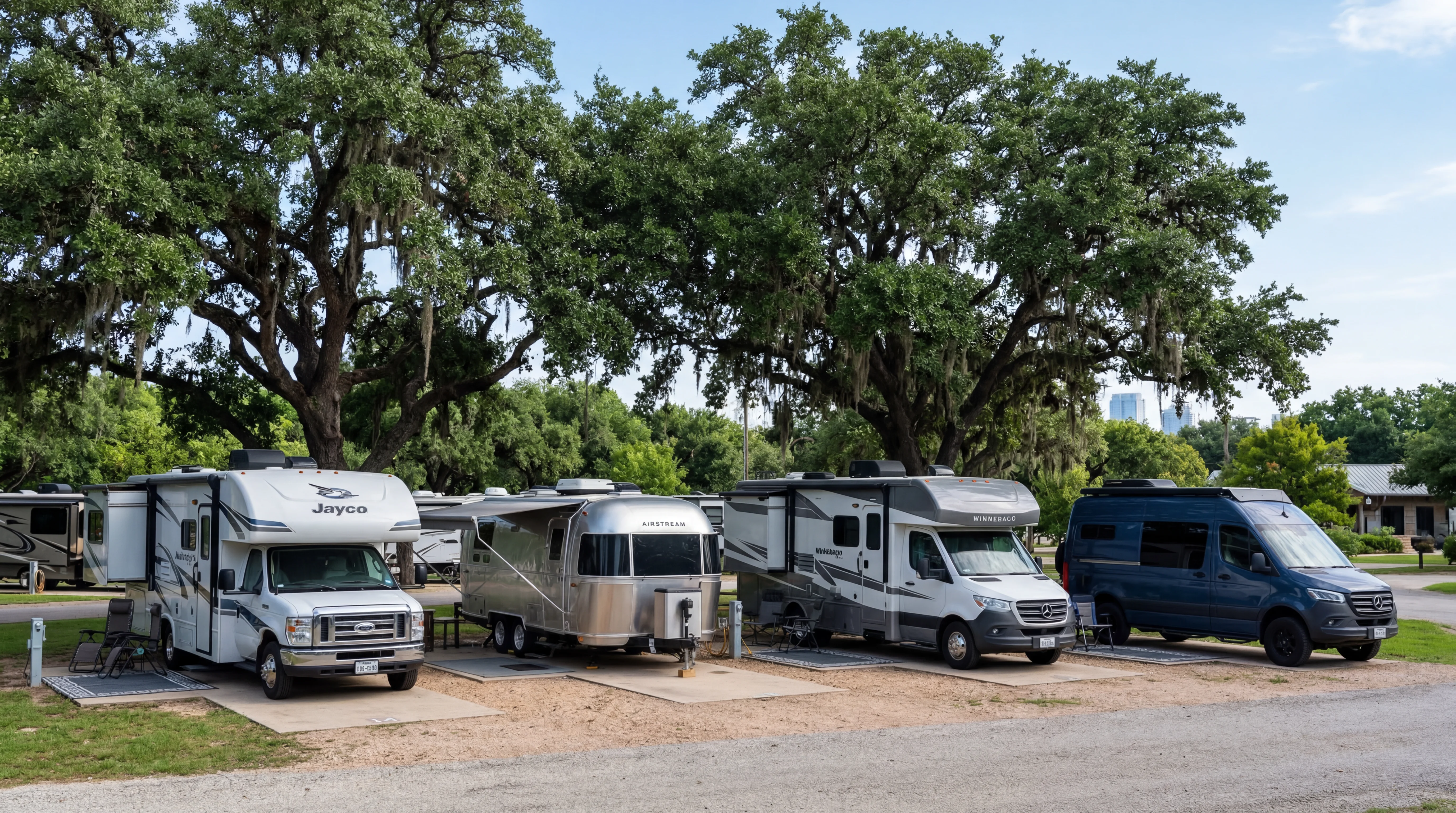 Row of modern RVs at an Austin Texas lot with Texas live oak trees
